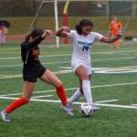 Shorewood senior Jasmyn Jacobs (right) lunges towards a 50/50 ball against Monroe junior Ella Glynn during the Stormrays 1-1 (4-2 penalty kicks) match against the Bearcats in the District 1 3A quarterfinals at Monroe High School on Saturday. (Joe Pohoryles / The Herald)