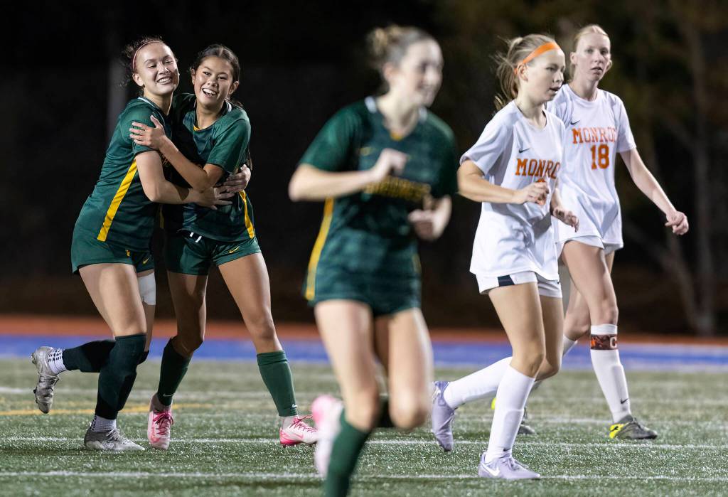 Shorecrests Olivia Taylor hugs Shorecrests Nemesia Peters after scoring a goal against Monroe during the 3A girls district game on Nov. 4, 2025 in Shoreline, Washington. (Olivia Vanni / The Herald)