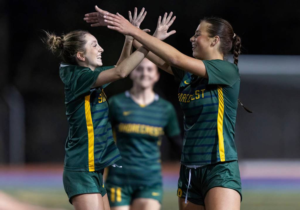 Shorecrests Sophia Tubbs and Kai Johnson hug after beating Monroe 4-1 in the 3A girls district game on Nov. 4, 2025 in Shoreline, Washington. (Olivia Vanni / The Herald)