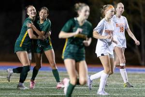 Shorecrest’s Olivia Taylor hugs Shorecrest’s Nemesia Peters after scoring a goal against Monroe during the 3A girls district game on Nov. 4, 2025 in Shoreline, Washington. (Olivia Vanni / The Herald)