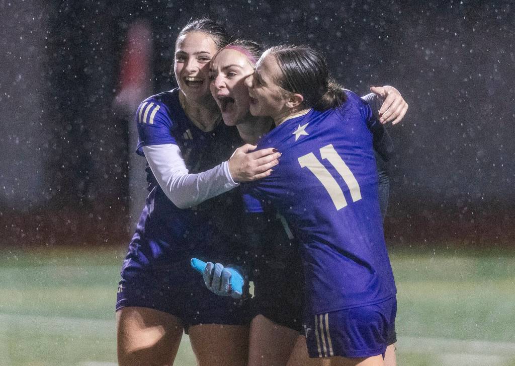 Lake Stevens Tessa Anastasi celebrates beating Jackson with Sami Heininger and Judith Roehl after the 4A girls district game on Nov. 5, 2025 in Lake Stevens, Washington. (Olivia Vanni / The Herald)