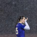 Lake Stevens Judith Roehl wipes her face as rain continues to fall during the 4A girls district game against Jackson on Nov. 5, 2025 in Lake Stevens, Washington. (Olivia Vanni / The Herald)