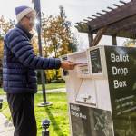 Eric Rasmussen drops his ballot in the ballot box outside of Town of Woodway Town Hall on Nov. 4, 2025 in Edmonds, Washington. (Olivia Vanni / The Herald)