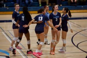 Meadowdale senior Violet DuBois (3) turns towards the bench while celebrating with her teammates after winning the second set in the Mavericks' 3-1 win against Shorecrest in a District 1 3A Tournament Play-in match at Meadowdale High School on Nov. 6, 2025. (Joe Pohoryles / The Herald)