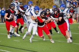Archbishop Murphy junior Jack Burns (8 in black) wraps up a Pullman ball-carrier for a third-down stop in the Wildcats' 51-7 win against the Greyhounds in a 2A winner-to-state playoff game at Terry Ennis Stadium on Nov. 8, 2025. (Joe Pohoryles / The Herald)