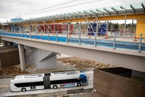A Community Transit bus drives underneath the Lynnwood Light Rail station on Thursday, April 4, 2024 in Lynnwood, Washington. (Olivia Vanni / The Herald)