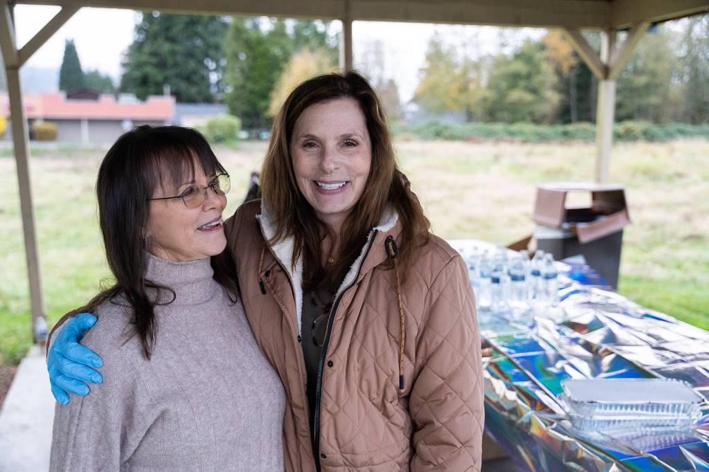 Will Geschke / The Herald 
Penelope Protheroe, left, the president of Angel Resource Connection, and Carie Claxton, a board member for the nonprofit, at the food distribution on Monday in Granite Falls.