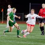 Edmonds-Woodway junior Audrey Rothmier (left) fights for a 50/50 ball against Silas sophomore Allison Conn during the Warriors 1-0 overtime loss to the Rams in the 3A Girls State Soccer Play-in Round at Edmonds Stadium on Nov. 12, 2025. (Joe Pohoryles / The Herald)