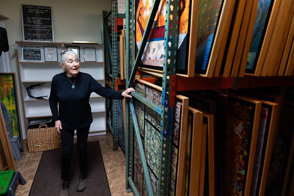 dElaine Herard Johnson with her paintings on Wednesday, Nov. 12, 2025 in Edmonds, Washington. (Will Geschke / The Herald)