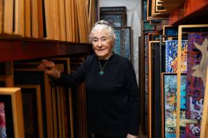 d’Elaine Herard Johnson poses for a portrait next to hundreds of her paintings in her Edmonds home on Wednesday, Nov. 12, 2025 in Edmonds, Washington. (Will Geschke / The Herald)