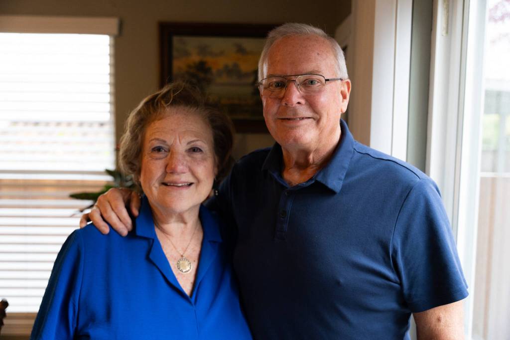 Roger Sharp, right, and his wife, Gina Sharp, in their Marysville home. (Will Geschke / The Herald)