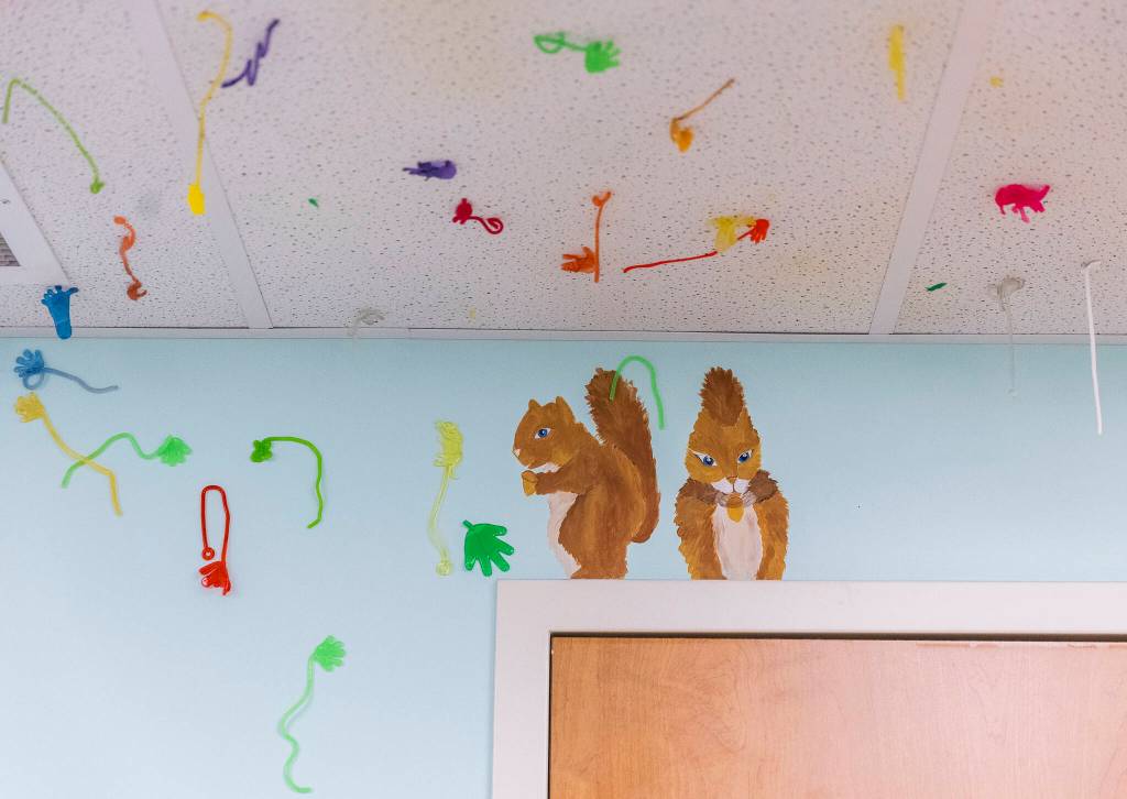 A mural of squirrels surrounded by sticky hands inside one of the children exam rooms at the Providence Intervention Center on Nov. 21, 2025 in Everett, Washington. (Olivia Vanni / The Herald)