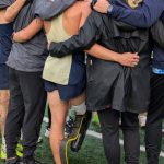 Arlington junior Ramon Little (center in gold) huddles with Eagles teammates and coaches (Photo courtesy Richard Little)
