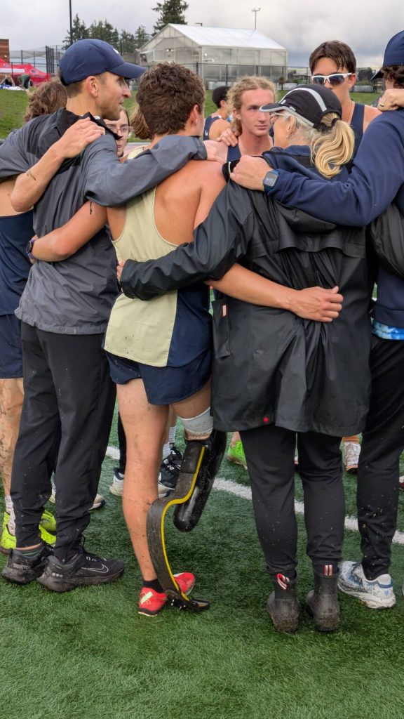 Arlington junior Ramon Little (center in gold) huddles with Eagles teammates and coaches (Photo courtesy Richard Little)