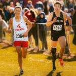 Arlington junior Ramon Little (right) runs alongside Stanwood's Max Grennell during the WIAA Cross Country State Championships at Sun Willows Golf Course in Pasco on Nov. 8, 2025. Little won the ambulatory championship in 12:29.2 on the 2.1-mile course, while Grennell competed as a partner in the unified race, which happened concurrently with the ambulatory race. (Photo courtesy Krissy Kolbeck / Arlington Cross Country / WIAA).