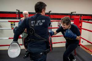 May Sinclaire, Dakota Stones mother, practices punching her body shield.