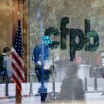 FILE — The Consumer Financial Protection Bureau logo is seen through a window at the CFPB offices in Washington on Sept. 23, 2019. Employees of the Consumer Financial Protection Bureau were instructed to cease “all supervision and examination activity” and “all stakeholder engagement,” effectively stopping the agency’s operations, in an email from the director of the Office of Management and Budget, Russell Vought, on Saturday, Feb. 8, 2025. (Ting Shen/The New York Times)