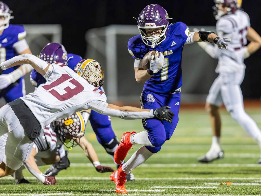 Lake Stevens Colten Fink escapes a tackle during the 4A state football quarterfinal game against Moses Lake on Nov. 22, 2025 in Lake Stevens, Washington. (Olivia Vanni / The Herald)