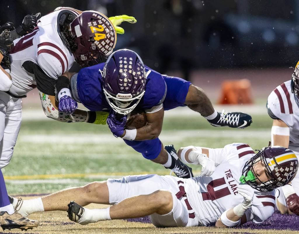 Lake Stevens Jayvian Ferrell jumps over a tackle during the 4A state football quarterfinal game against Moses Lake on Nov. 22, 2025 in Lake Stevens, Washington. (Olivia Vanni / The Herald)