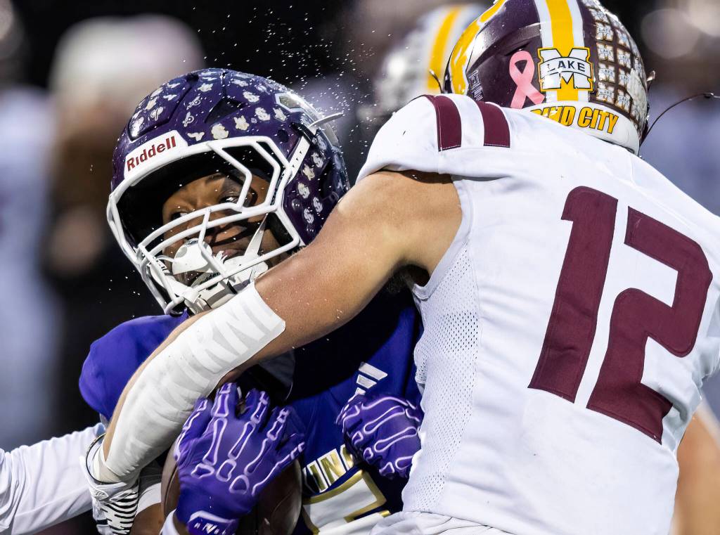 Water sprays off of Lake Stevens Jayvian Ferrell as he is tackled during the 4A state football quarterfinal game against Moses Lake on Nov. 22, 2025 in Lake Stevens, Washington. (Olivia Vanni / The Herald)