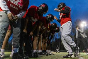 Archbishop Murphy’s Evan Ruiz relays a play call while the team runs through plays during practice on Nov. 24, 2025 in Everett, Washington. (Olivia Vanni / The Herald)