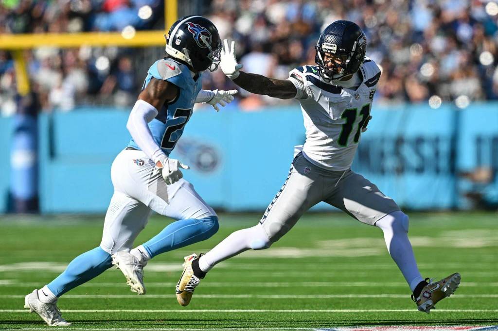 Jaxon Smith-Njigba (11) of the Seattle Seahawks stiffarms a Tennessee Titan in a game at Nissan Stadium on Sunday in Nashville, Tennessee. (Photo courtesy of the Seattle Seahawks)