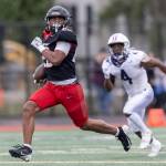 Archbishop Murphys Isaiah Smith runs the ball upfield to the end zone for a touchdown during the 2A state football semifinal game against Anacortes on Nov. 29, 2025 in Everett, Washington. (Olivia Vanni / The Herald)