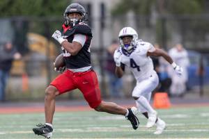 Archbishop Murphy’s Isaiah Smith runs the ball upfield to the end zone for a touchdown during the 2A state football semifinal game against Anacortes on Nov. 29, 2025 in Everett, Washington. (Olivia Vanni / The Herald)
