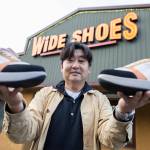 Wide Shoes owner Dominic Ahn outside of his store along 205th Street on Nov. 20, 2025 in Edmonds, Washington. (Olivia Vanni / The Herald)
