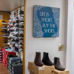 Lina Ahn, the original owner of Wide Shoes, works in the back of the store along 205th Street on Nov. 20, 2025 in Edmonds, Washington. (Olivia Vanni / The Herald)