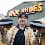 Wide Shoes owner Dominic Ahn outside of his store along 205th Street on Nov. 20, 2025 in Edmonds, Washington. (Olivia Vanni / The Herald)