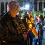 Ian Meyer listens to speakers during a World AIDS Day event at the AIDS Memorial on the Snohomish County Campus on Dec. 1, 2025 in Everett, Washington. (Olivia Vanni / The Herald)