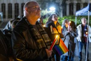 Ian Meyer listens to speakers during a World AIDS Day event at the AIDS Memorial on the Snohomish County Campus on Dec. 1, 2025 in Everett, Washington. (Olivia Vanni / The Herald)