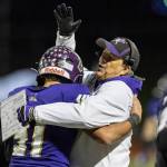Lake Stevens head coach Tom Tri hugs Lake Stevens Kenny Buckmiller during the 4A state football quarterfinal game against Moses Lake on Nov. 22, 2025 in Lake Stevens, Washington. (Olivia Vanni / The Herald)