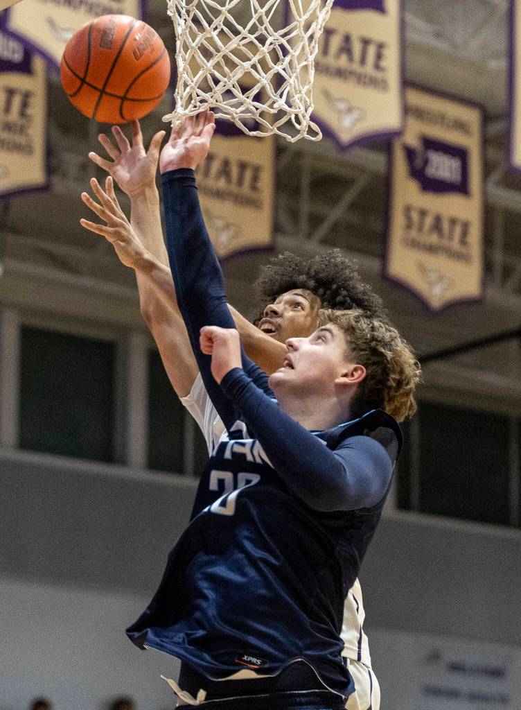 Lake Stevens Devin Freeman jumps for a rebound against Tenison Woods during the game on Dec. 2, 2025 in Lake Stevens, Washington. (Olivia Vanni / The Herald)