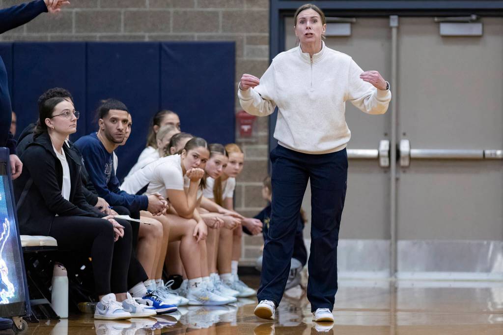Arlington head coach Lauryn Perrigo reacts to a shot made by Stanwood during the game on Dec. 3, 2025 in Arlington, Washington. (Olivia Vanni / The Herald)