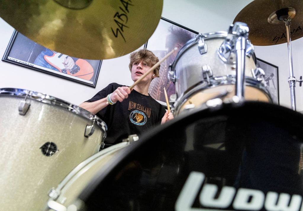 Finley Pettit, 15, drums during a group lesson at The Music Circle on Dec. 1, 2025, in Everett, Washington. (Olivia Vanni / The Herald)