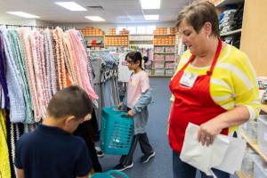 Aleen Alshamman carries her basket as she picks out school clothes with the help of Operation School Bell volunteers on Sept. 24, 2025 in Everett, Washington. (Olivia Vanni / The Herald)