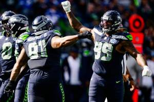 Leonard Williams (99) and Byron Murphy II (91) of the Seattle Seahawks celebrate during the third quarter of the game against the New Orleans Saints at Lumen Field on September 21, 2025 in Seattle, Washington. (Jane Gershovich / Getty Images / The Athletic)