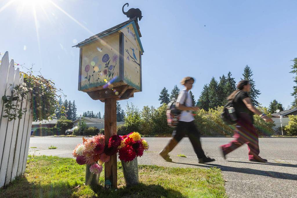 Students walk by Jacobson’s Little Free Library along Beverly Lane on Sept. 16, 2025 in Everett, Washington. (Olivia Vanni / The Herald)
