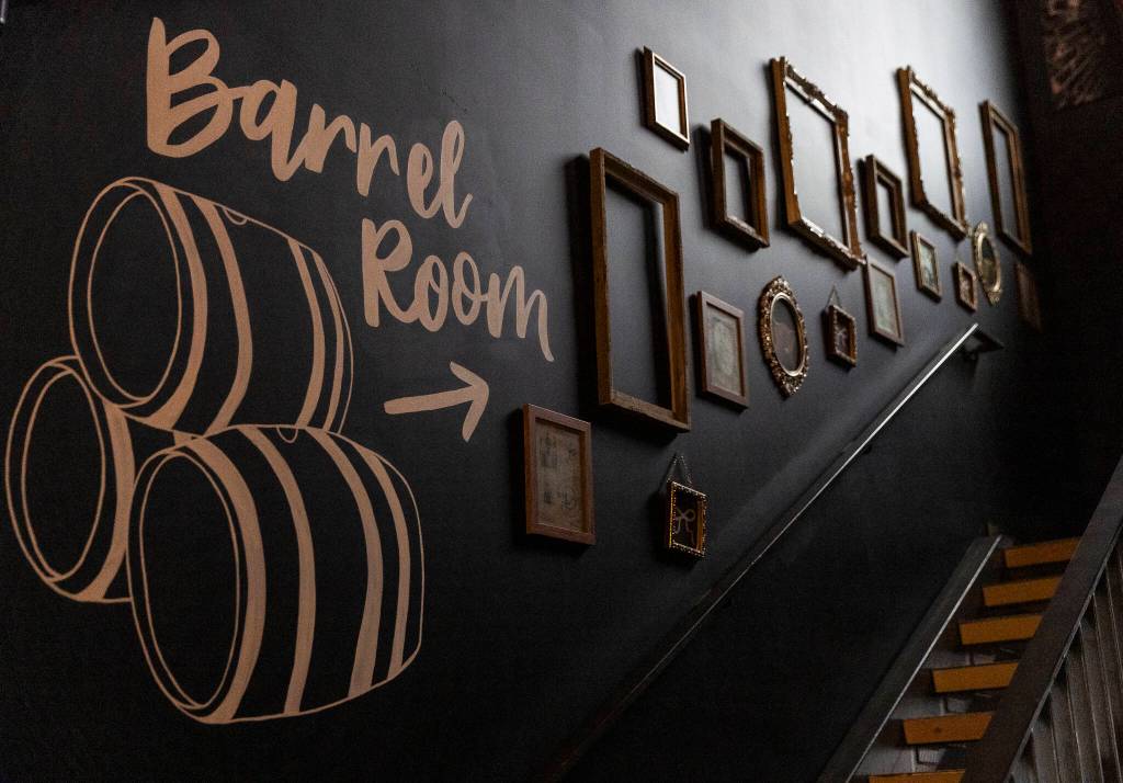 Stairs leading up to the Barrel Room and second story room and deck at the Rustic Cork Wine Bar on Dec. 2, 2025 in Everett, Washington. (Olivia Vanni / The Herald)