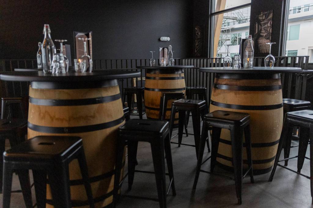 Bar tables in the Barrel Room of the Rustic Cork Wine Bar on Dec. 2, 2025 in Everett, Washington. (Olivia Vanni / The Herald)
