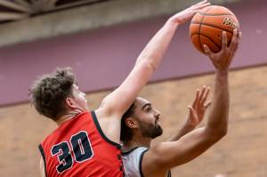 Snohomish’s Deyton Wheat blocks a shot by Mountlake Terrace’s Svayjeet Singh during the 3A district loser-out playoff game on Thursday, Feb. 13, 2025 in Mountlake Terrace, Washington. (Olivia Vanni / The Herald)