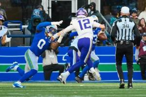 Seahawks defensive end DeMarcus Lawrence (0) pulls down Minnesota Vikings quarterback Max Brosmer (12), who threw a pick-six on the play during a game at Lumen Field in Seattle, Washington on Sunday, Nov. 30, 2025. (Photo courtesy of the Seattle Seahawks)