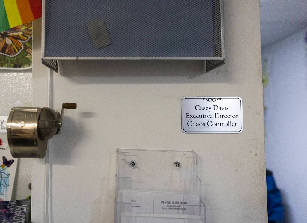 A nameplate declaring Casey Davis as the chaos controller is visible outside of her small makeshift office space at the Edmonds Food Bank on Dec. 8, 2025, in Edmonds, Washington. (Olivia Vanni / The Herald)