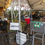Volunteers bring carts back inside after food is delivered to customers cars at the Edmonds Food Bank on Dec. 8, 2025, in Edmonds, Washington. (Olivia Vanni / The Herald)