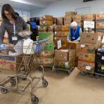 Volunteers Erin Keeton, left, and Judy OMalley, right, put together a customers order at the Edmonds Food Bank on Dec. 8, 2025, in Edmonds, Washington. (Olivia Vanni / The Herald)