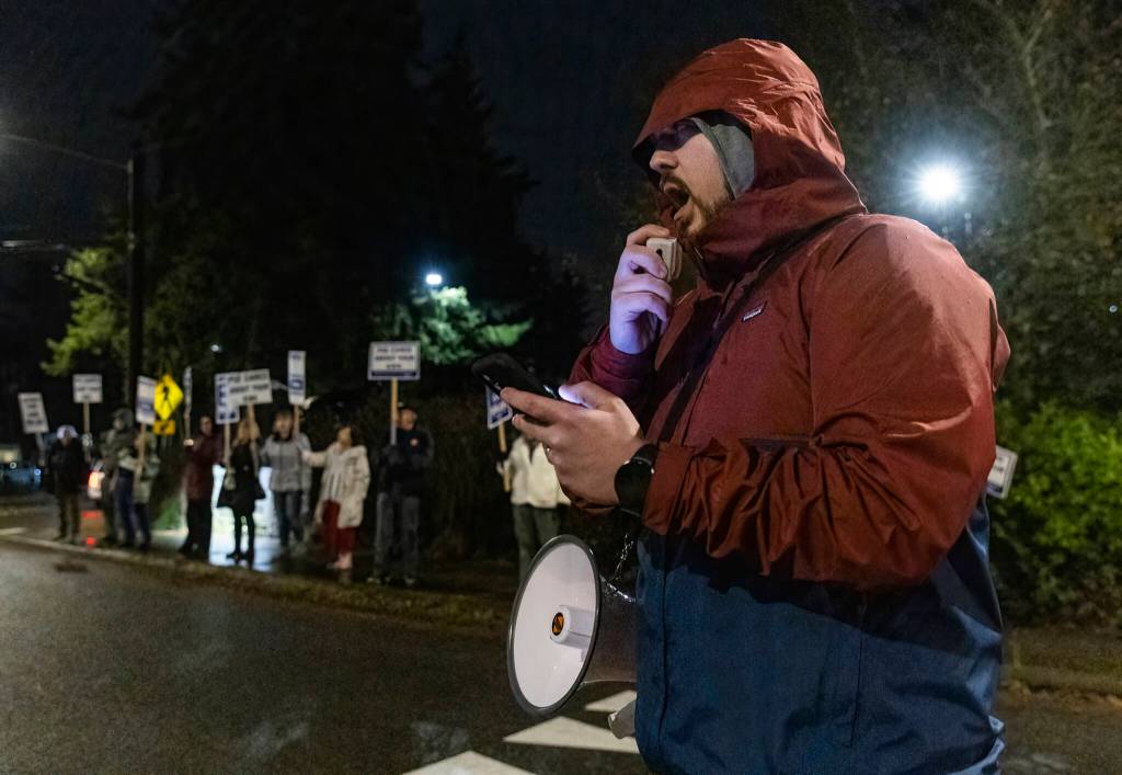 Phoenix Horn leads chants during a rally outside of the Edmonds School District building on Tuesday, Dec. 9, 2025, in Edmonds, Washington. (Olivia Vanni / The Herald)