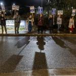 People line the sidewalk outside of the Edmonds School District building on Tuesday, Dec. 9, 2025, in Edmonds, Washington. (Olivia Vanni / The Herald)