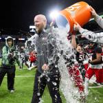 Archbishop Murphy head coach Joe Cronin has ice water dumped on him after winning the 2A state championship game against Tumwater at Husky Stadium on Saturday, Dec. 6, 2025 in Seattle, Washington. (Olivia Vanni / The Herald)